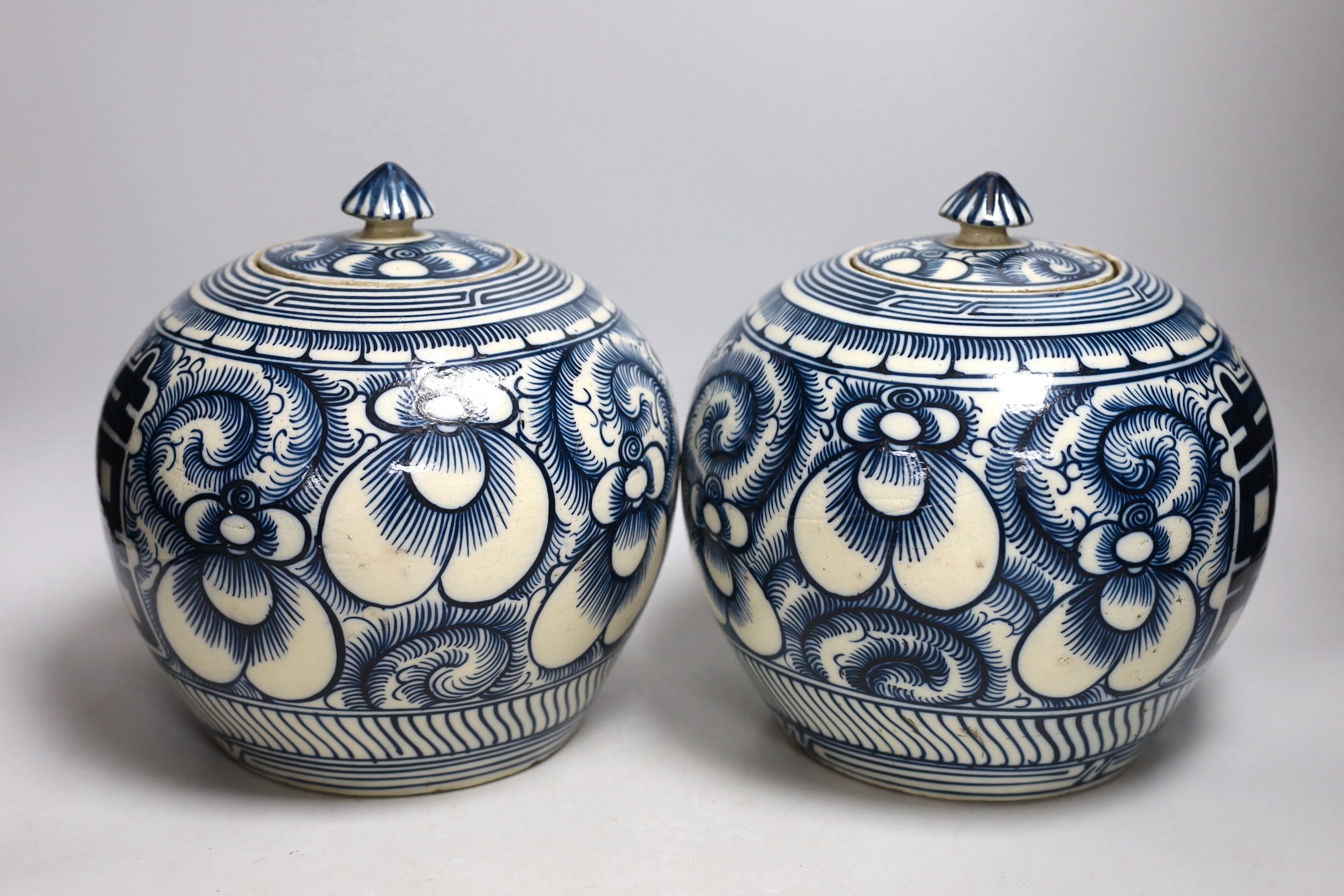 A pair of Chinese blue and white ‘Shuangxi’ jars and cover, 25cms high
